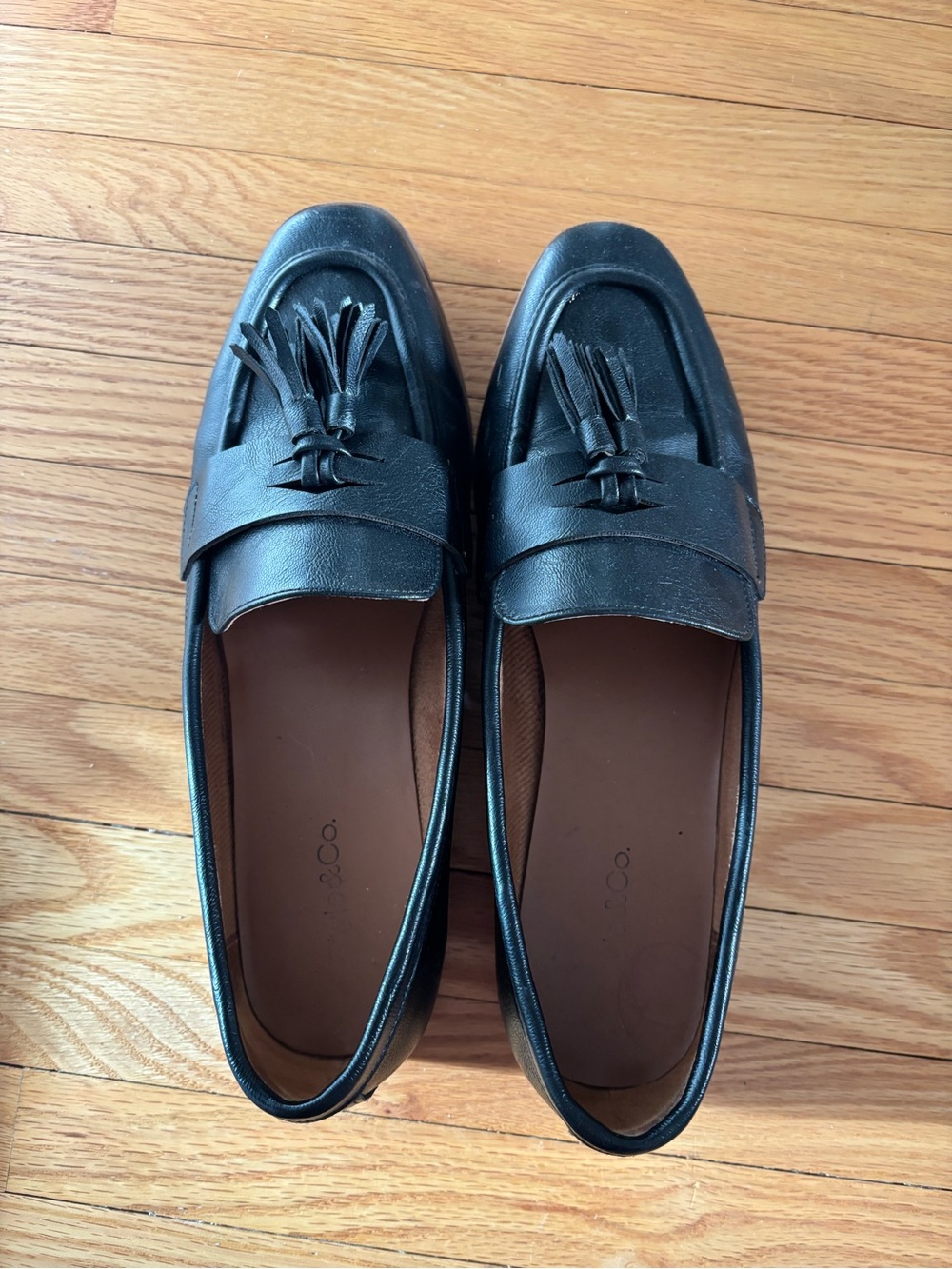 Black tasseled penny loafers